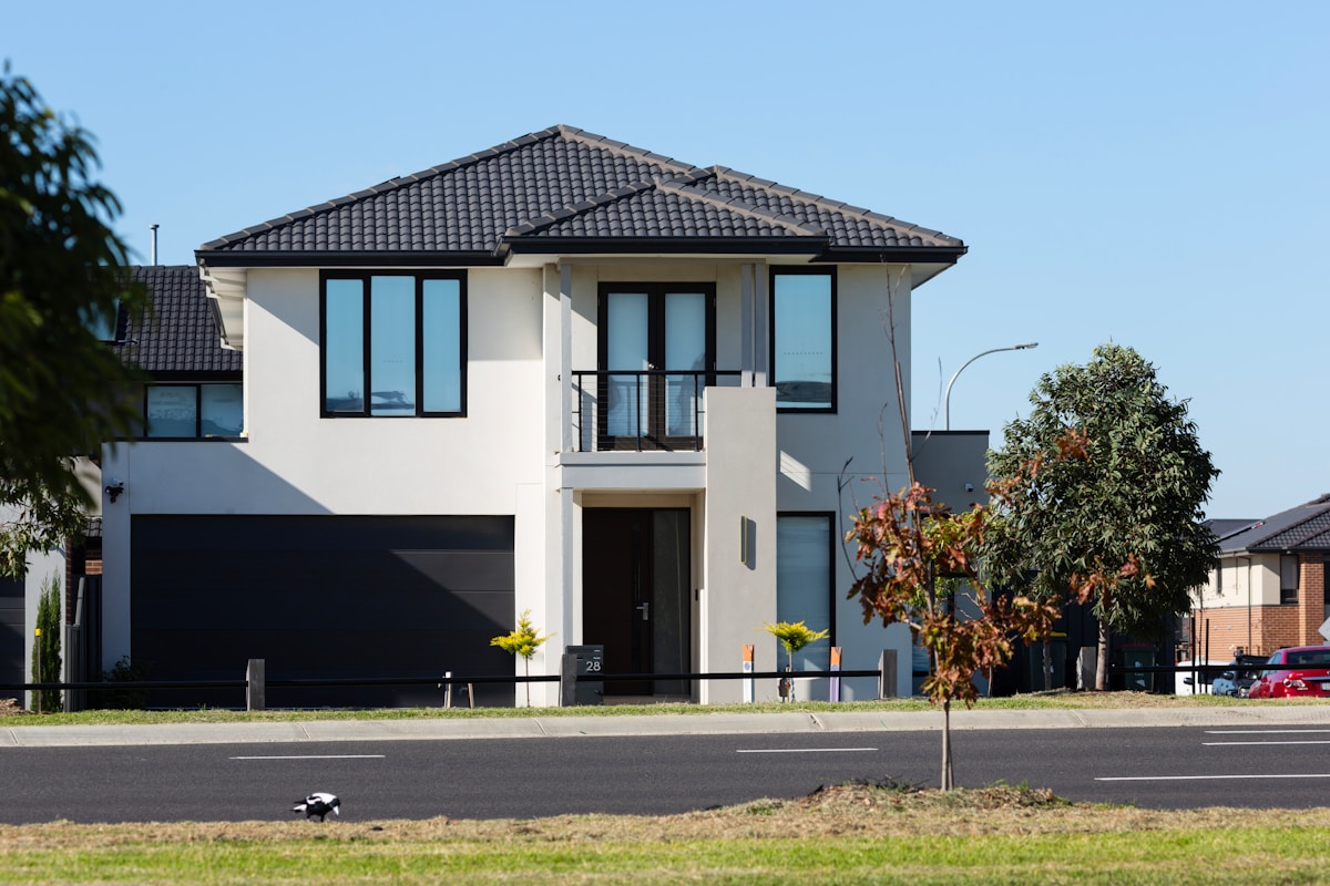 Modern suburban house with garden and clear sky